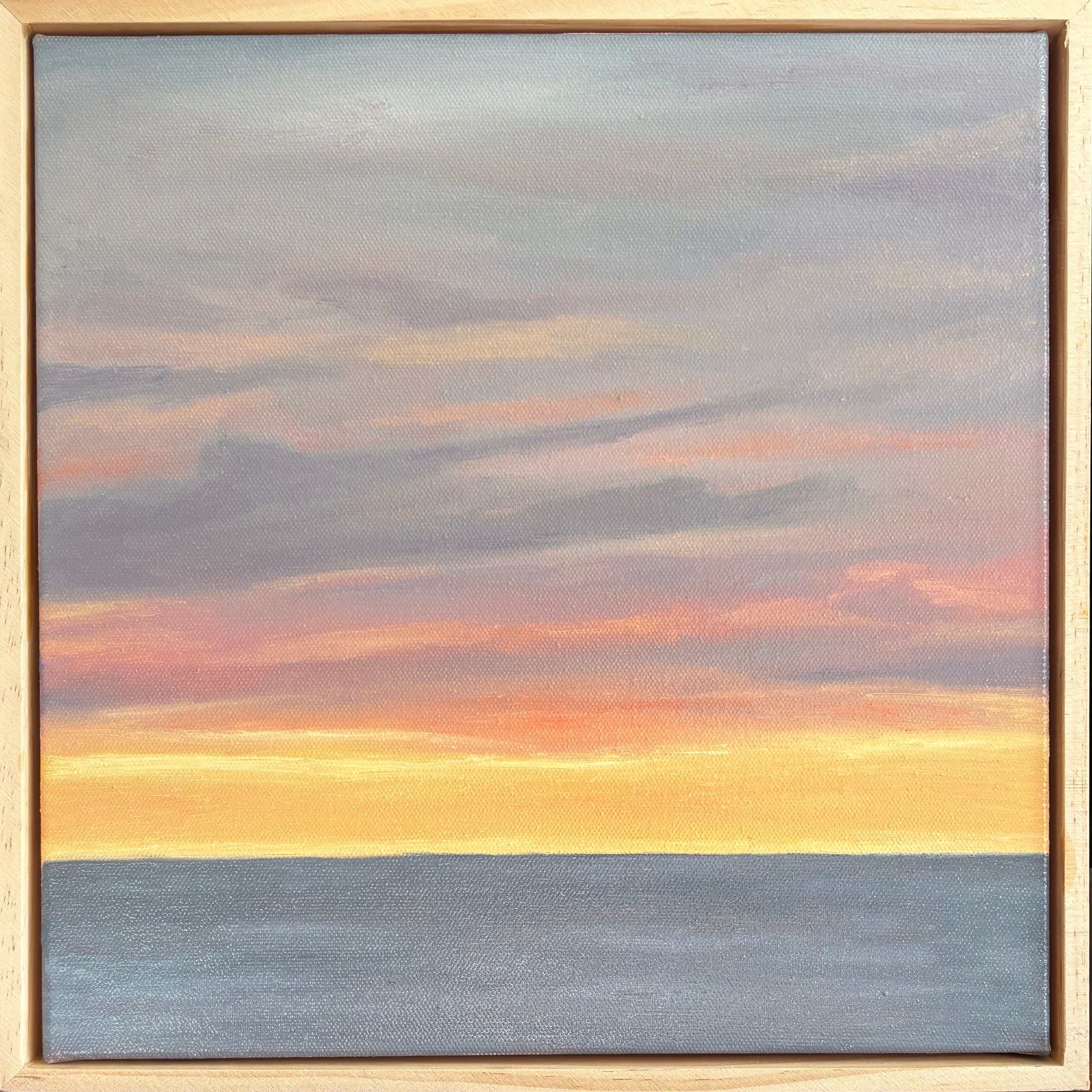 Painting of a sunset over water with a wooden frame